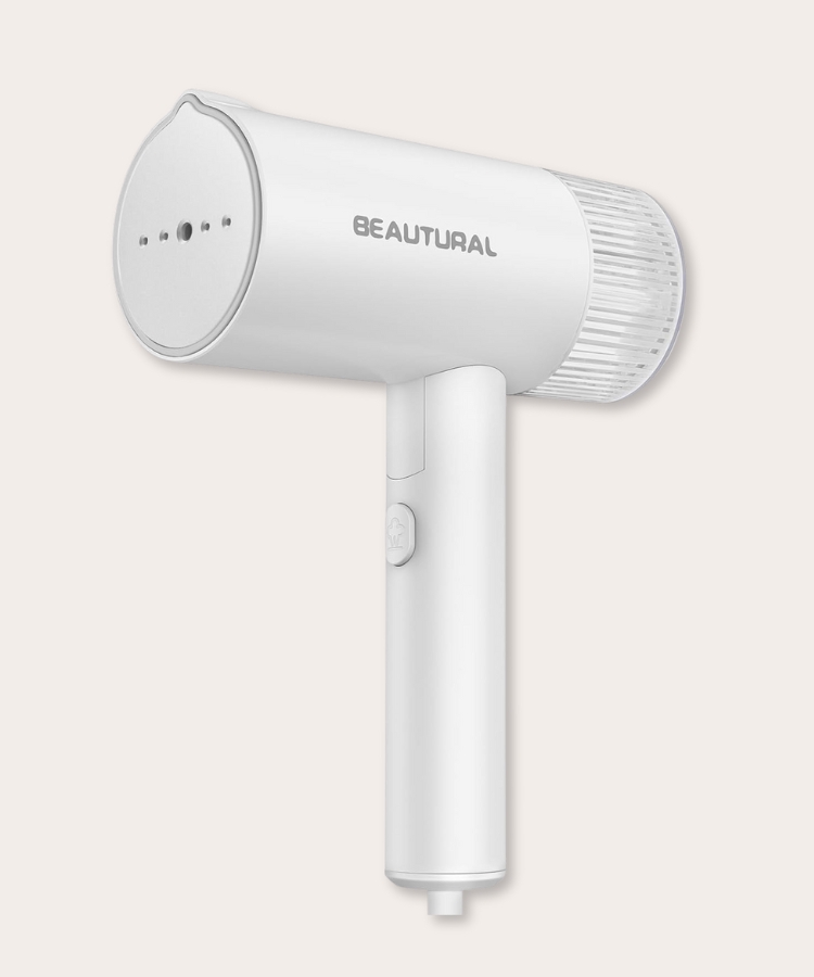 Close-up of a compact foldable clothing steamer.