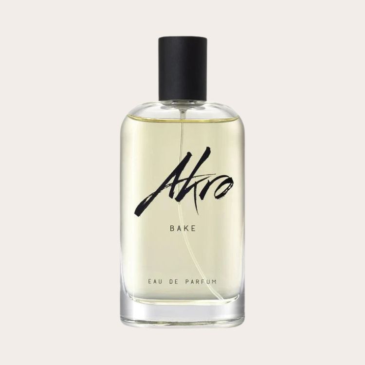 Clear glass bottle of Akro BAKE Eau de Parfum featuring elegant black lettering.