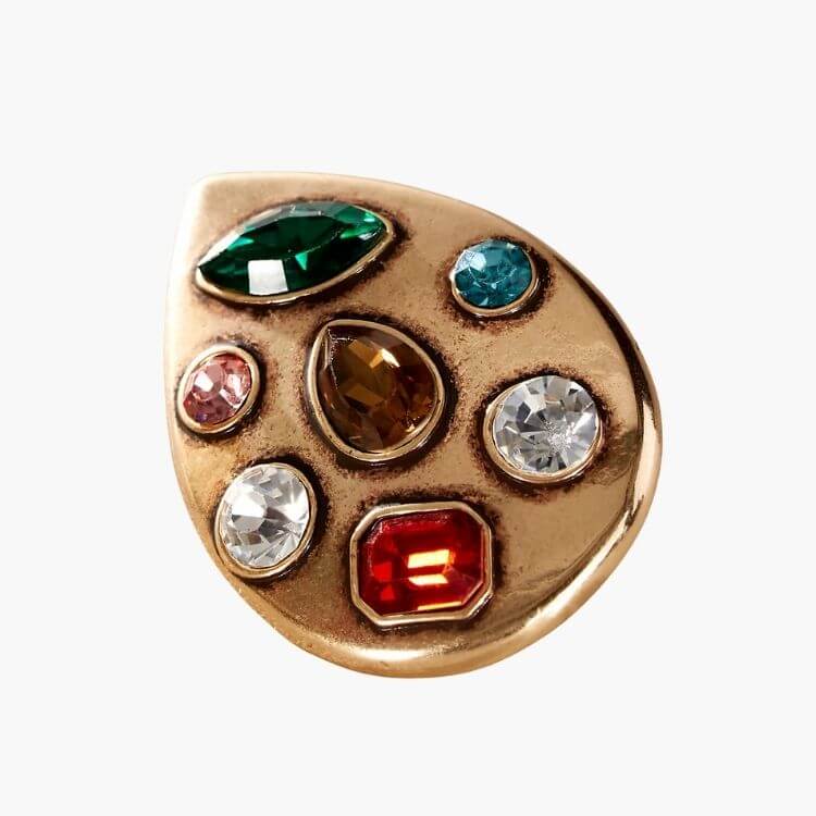 A large brooch with multi-colored gemstones set in a gold-tone frame.