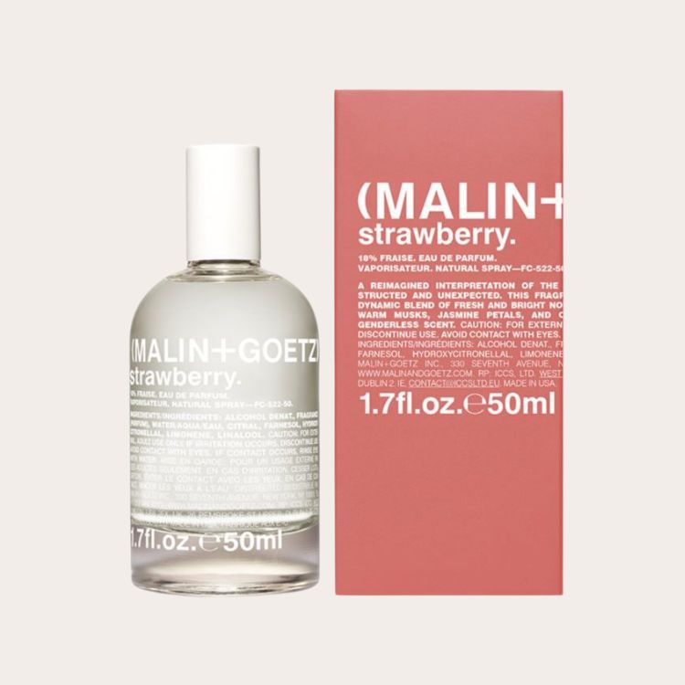 Malin + Goetz Strawberry Eau de Parfum bottle next to its pink packaging.