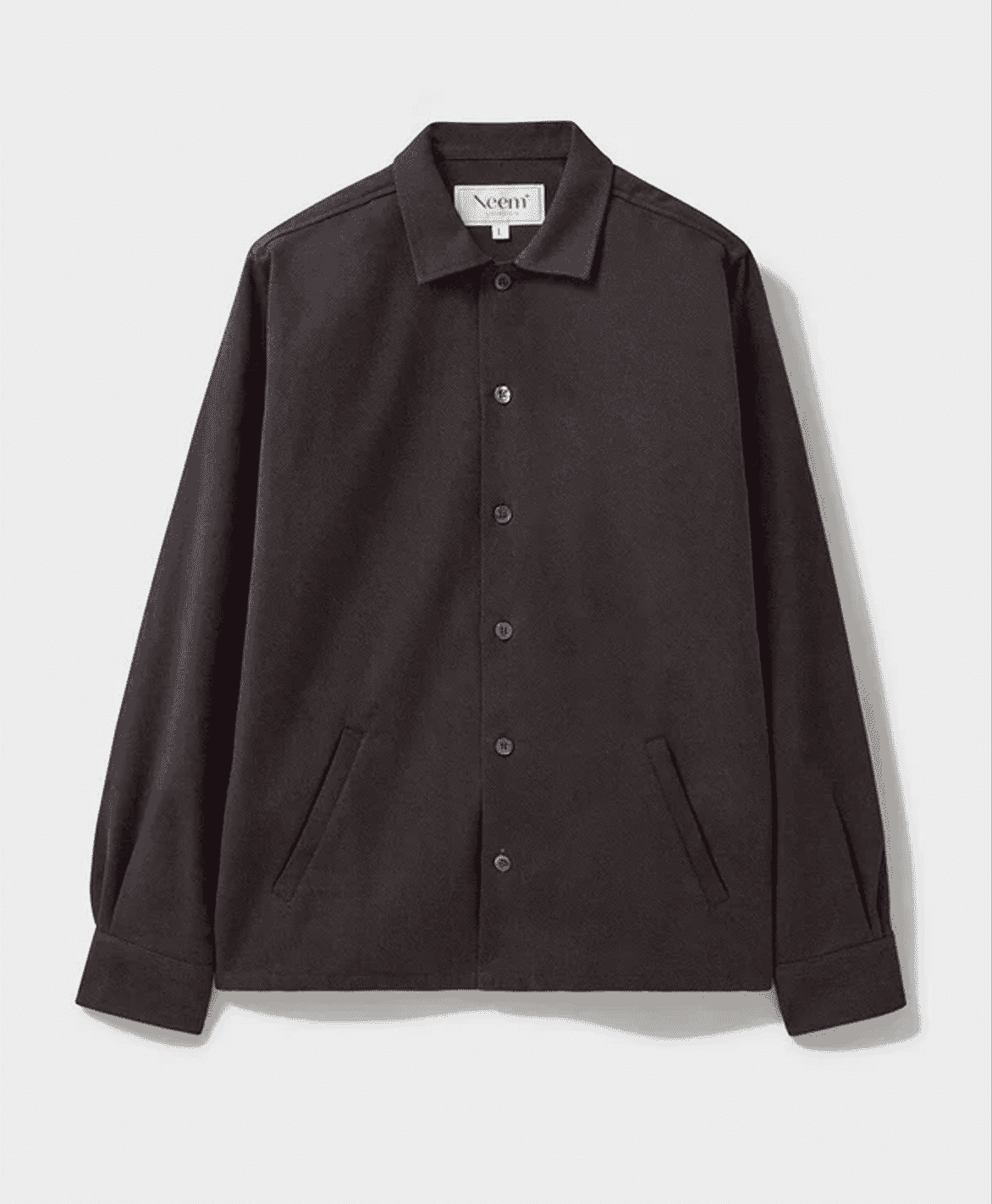 Detailed shot of a man wearing a dark olive Recycled Italian Heavy Twill Jacket.