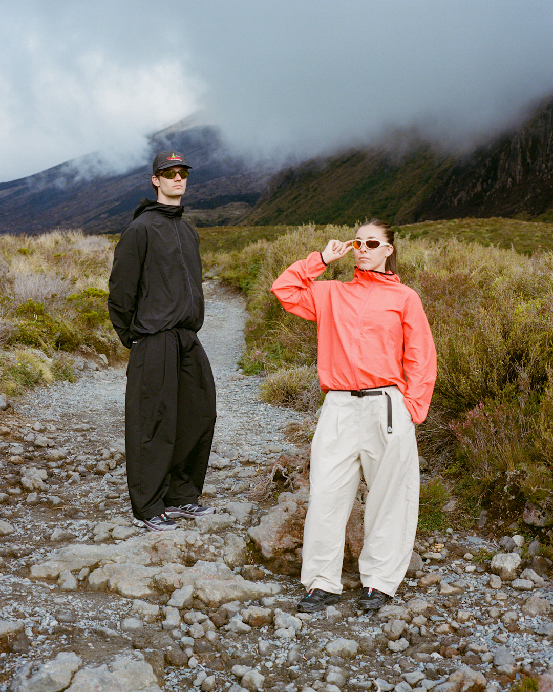 Frontal view of the double-pleated hiking pants showing the integrated belt and relaxed fit.