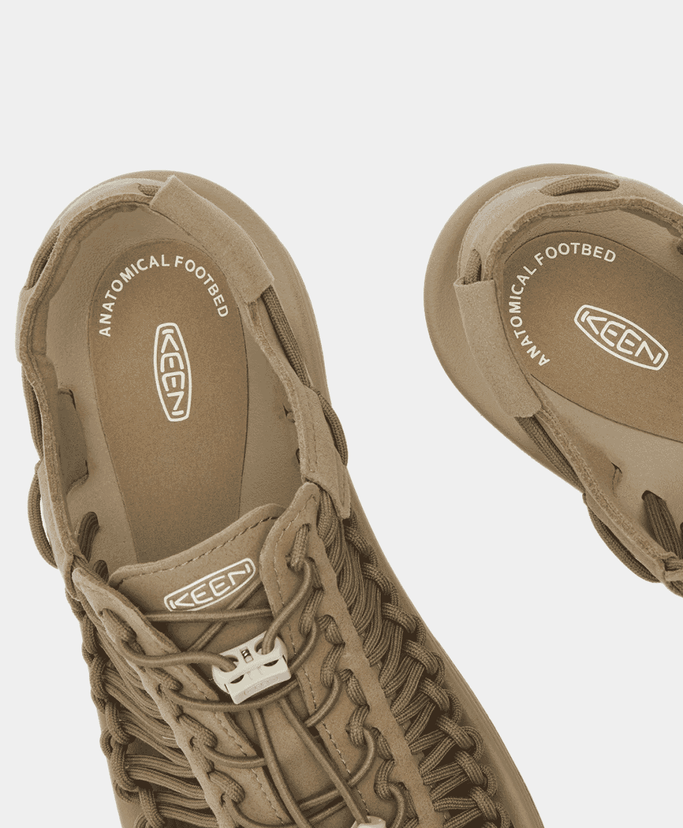 Close-up of the textured anatomical footbed of a beige KEEN sandal.