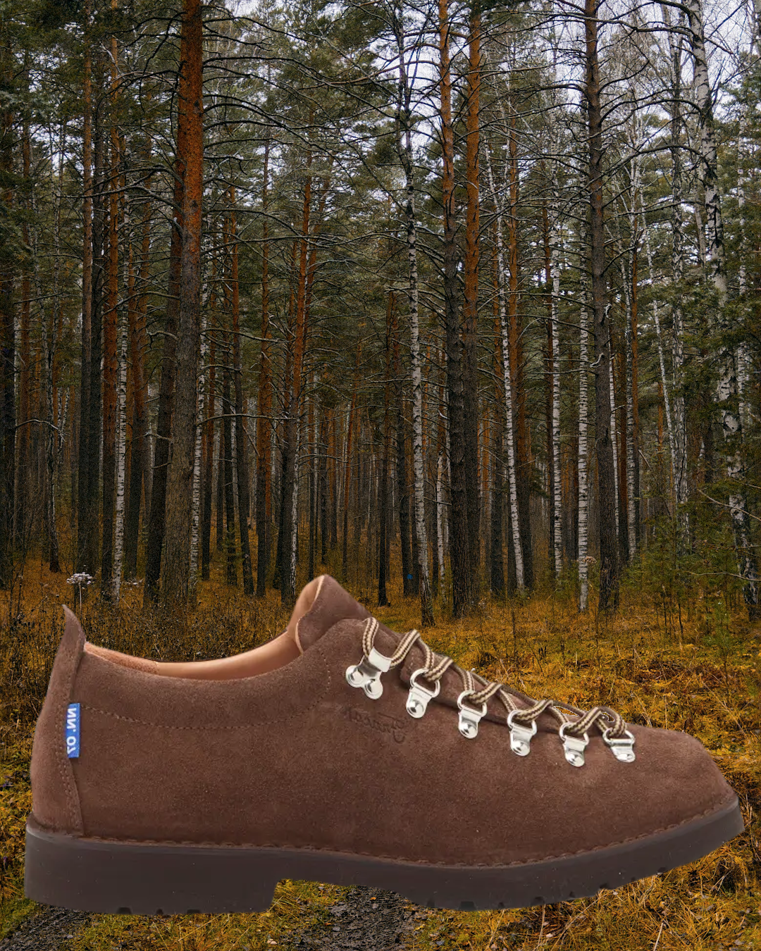A wide-angle shot of low-top hikers resting under a wooden pub table alongside a pint of beer.