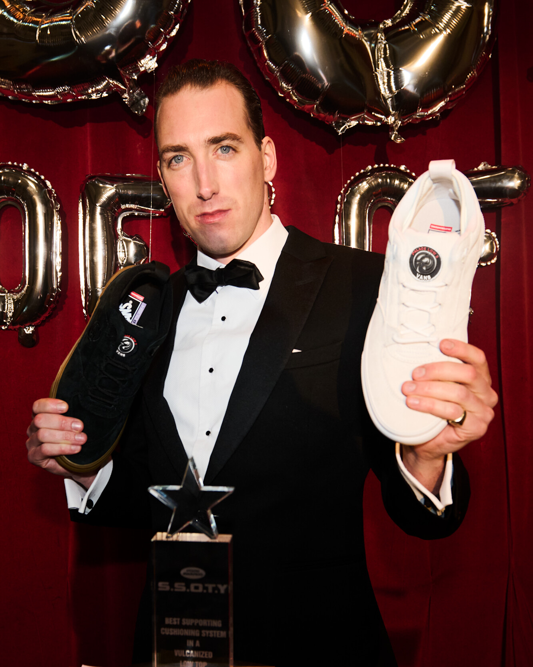 A skater performing a dynamic trick on a textured London street in the Palace x Vans Low 2.