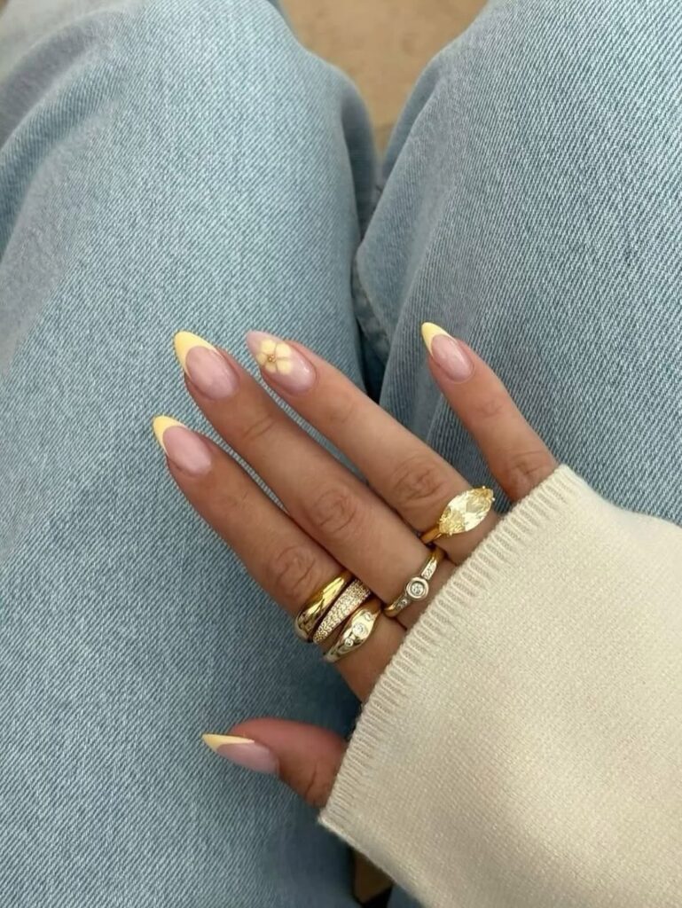 High-shine butter yellow manicure with a chrome finish.