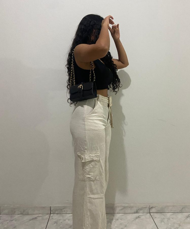 A model wearing wide-leg cargo pants with streamlined side pocket details.