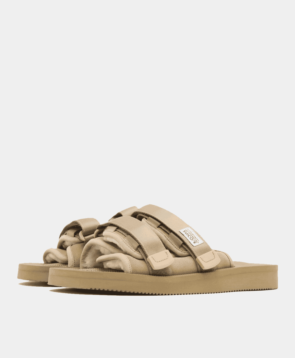 Beige Suicoke slides with thick platform soles and velcro straps.