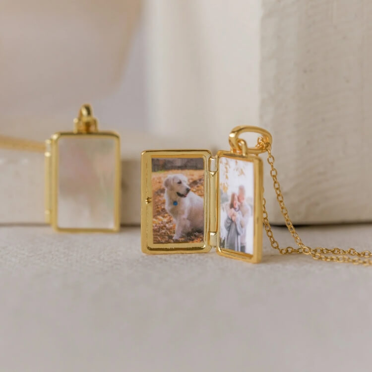 A close-up of a gold photo locket necklace.