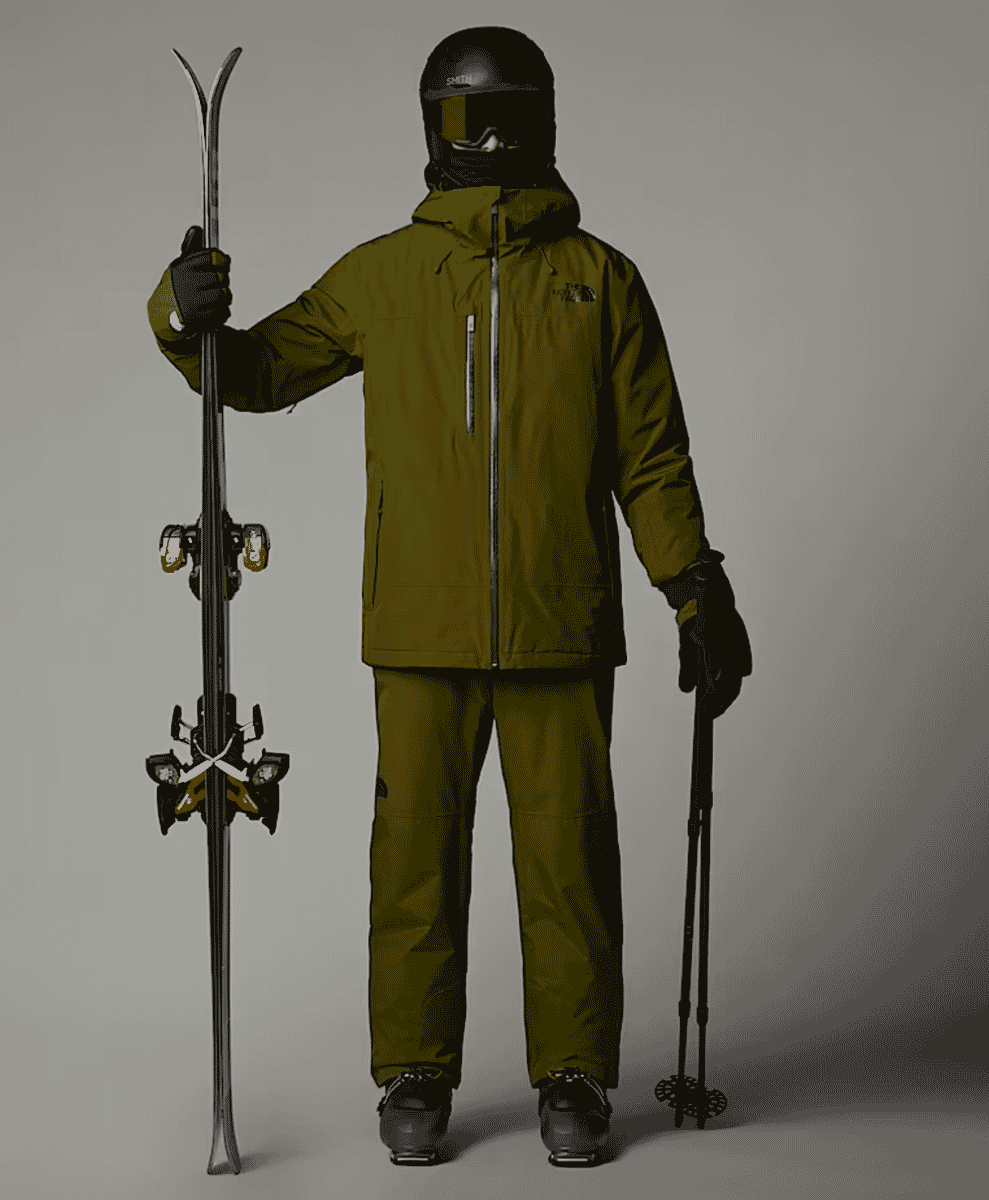 A model in full olive green The North Face ski gear stands against a neutral studio background.