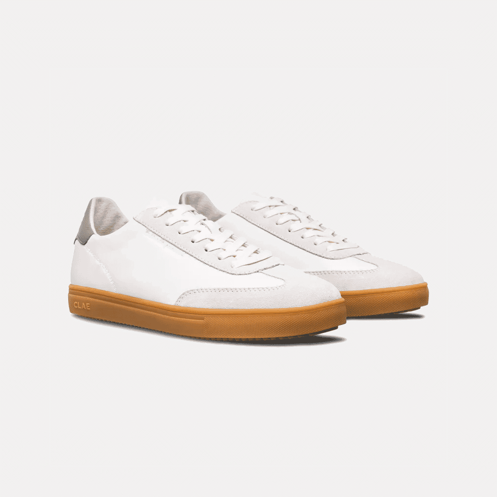White and beige low-top sneakers with gum-colored rubber soles and minimalist design.
