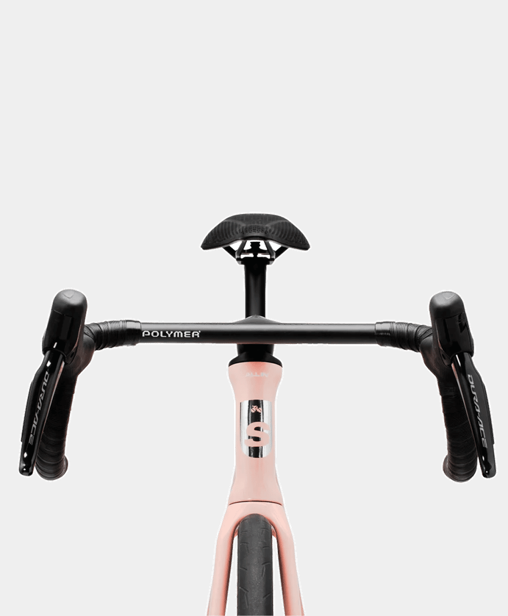 Front view of a pink Polymer road bicycle with black handlebars and high-performance components.