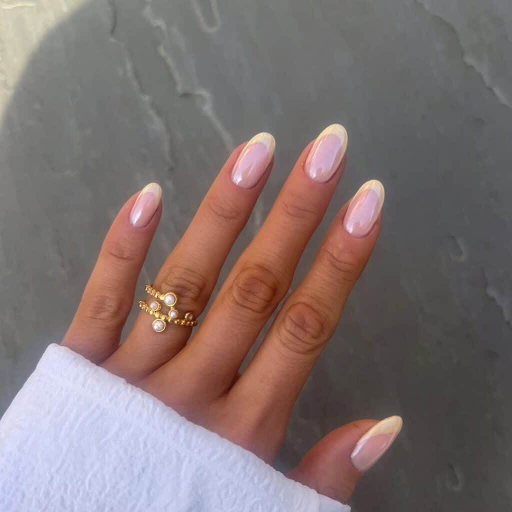 Butter yellow nails with subtle 3D floral accents.