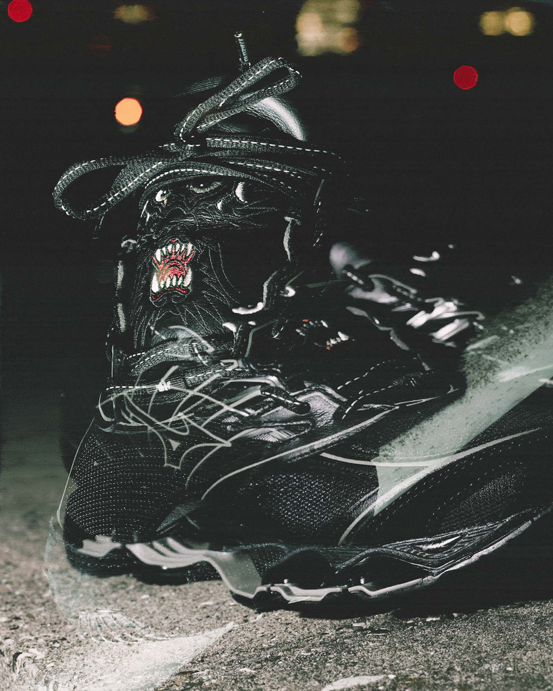 Clean studio shot of the Maharishi x Mizuno Wave Prophecy LS on a neutral grey background.