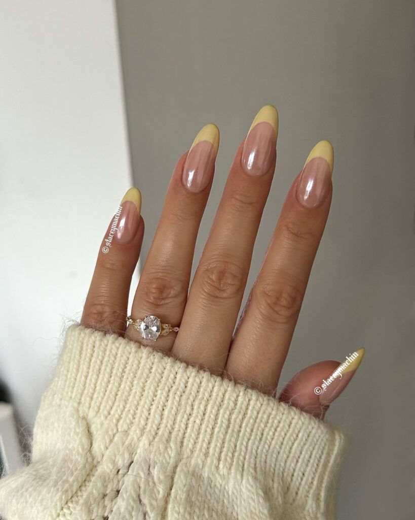 Clean butter yellow gel manicure on short, rounded nails.