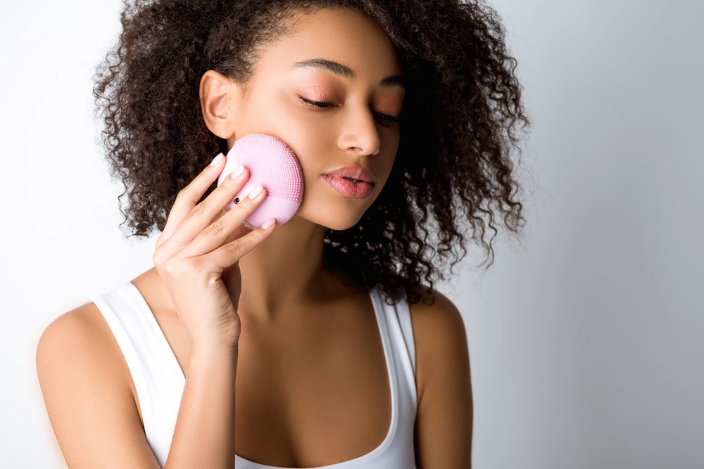 Detailed shot of skincare bottles and the smooth texture of a cream cleanser.