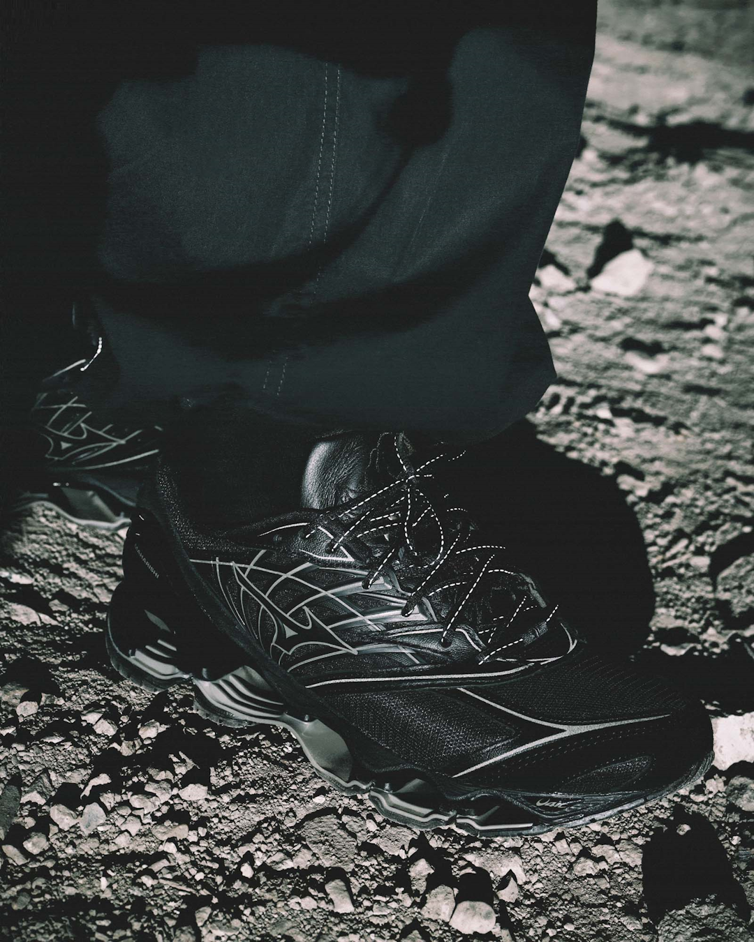 Macro close-up of the dragon face embroidery on the sneaker tongue.