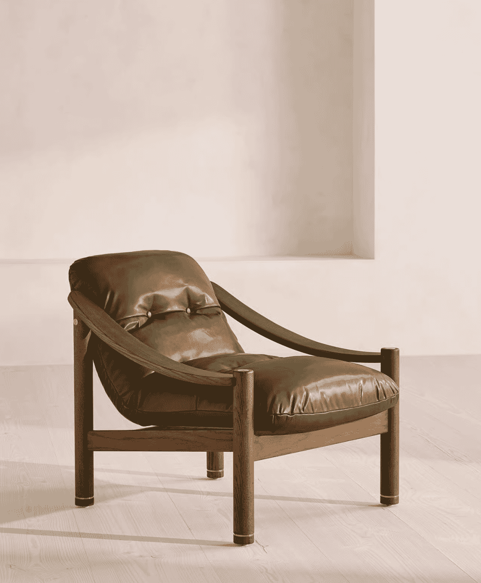 A modern armchair featuring a dark-stained wooden frame and premium brown leather upholstery.