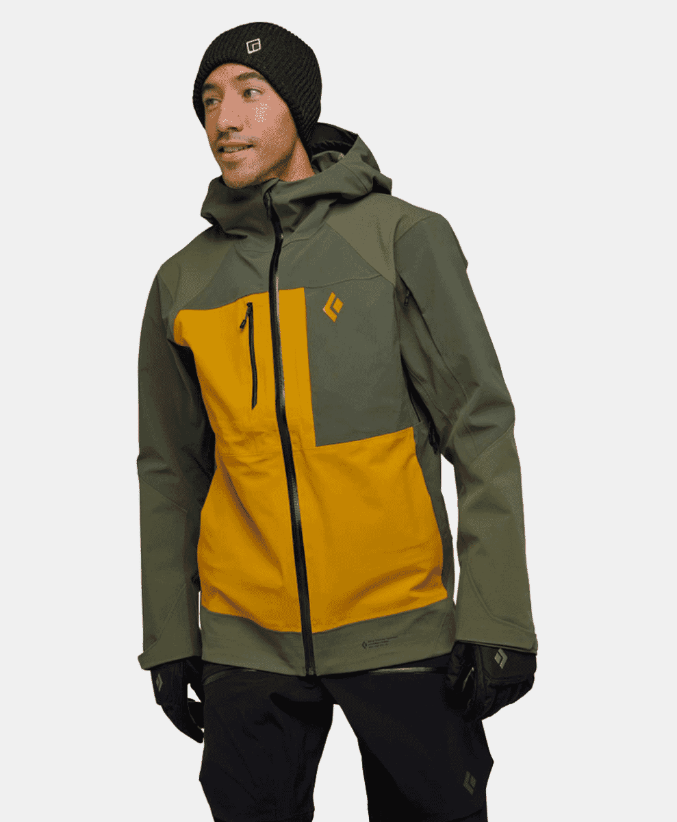 A man models an olive and mustard yellow color-blocked ski jacket.