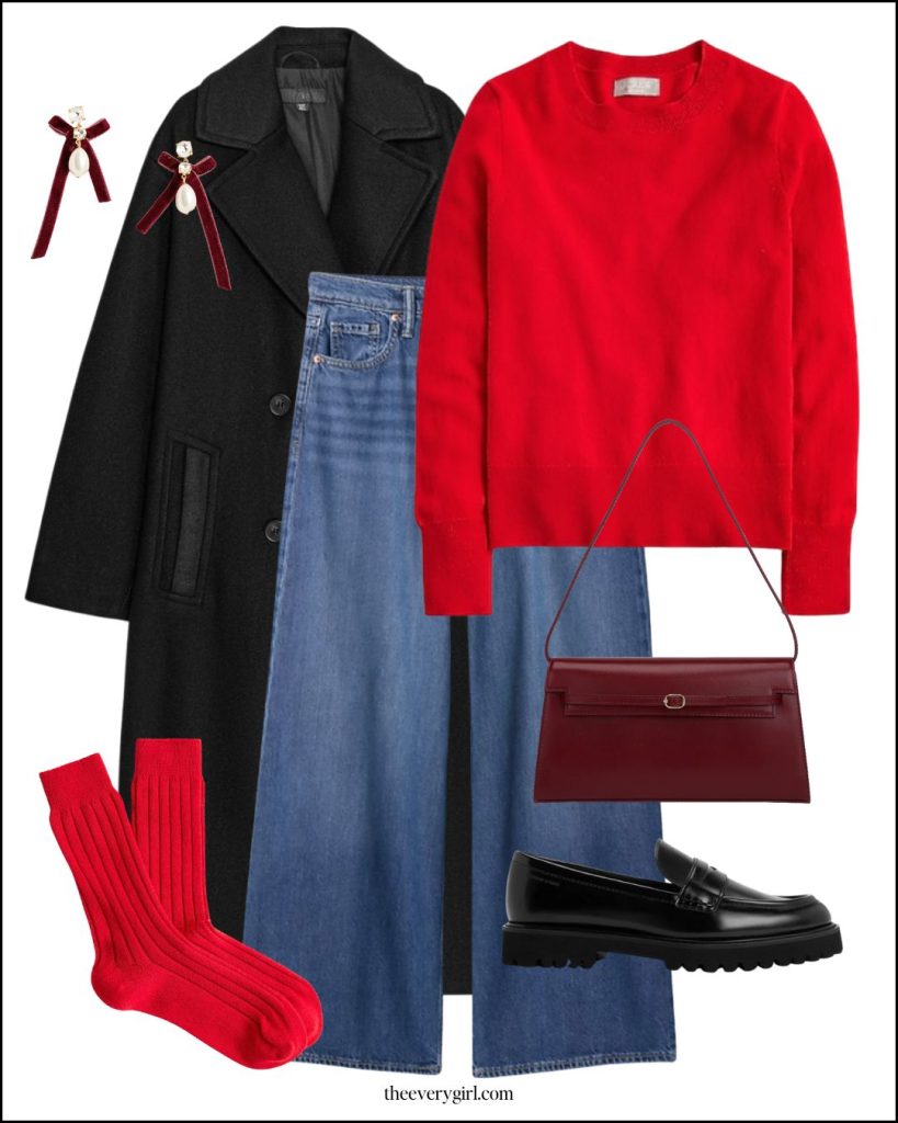 A red sweater layered under a wool coat with loafers and visible socks.