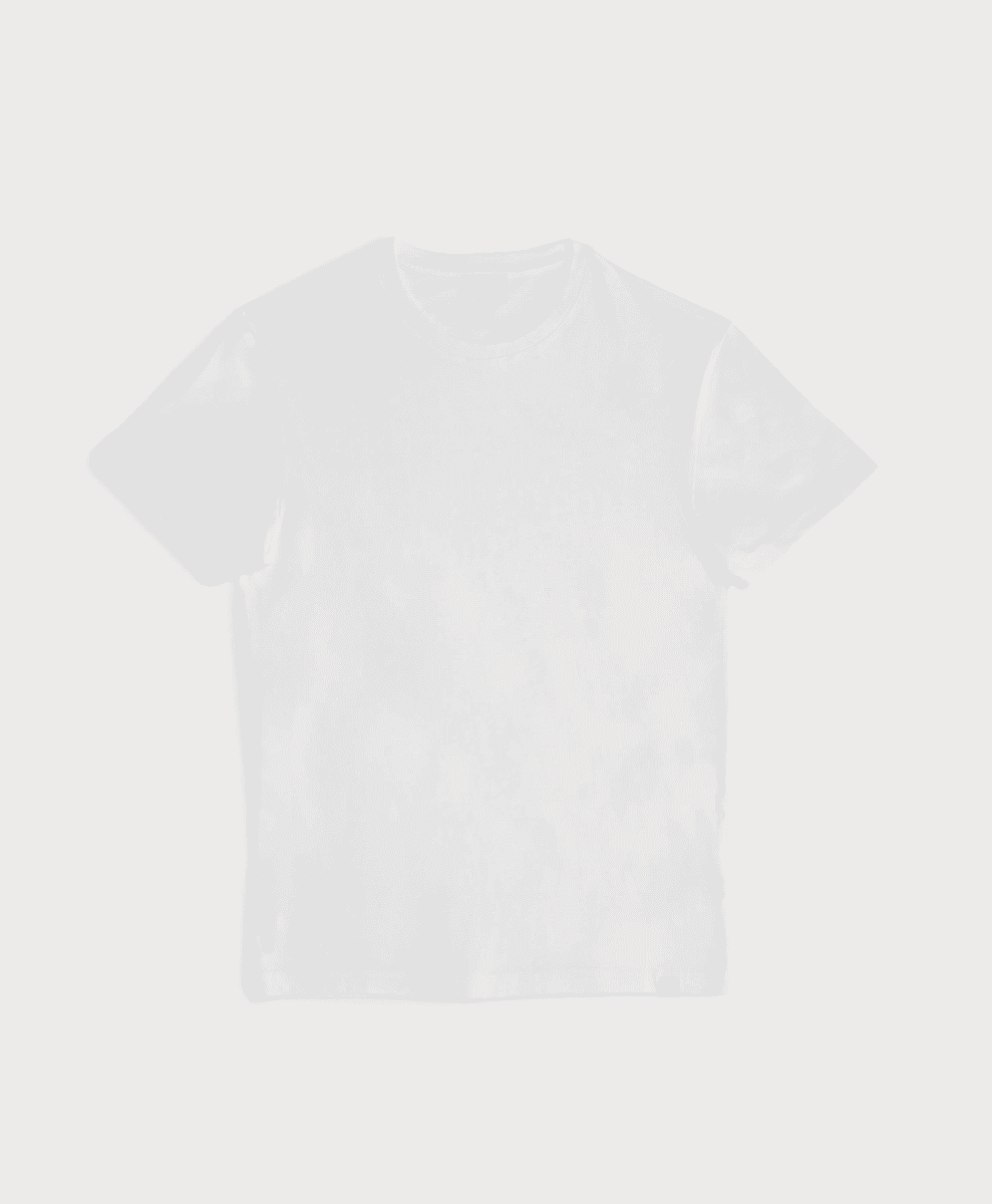 A man wearing a well-fitted white SANVT T-shirt showing the idealized length relative to the waist.
