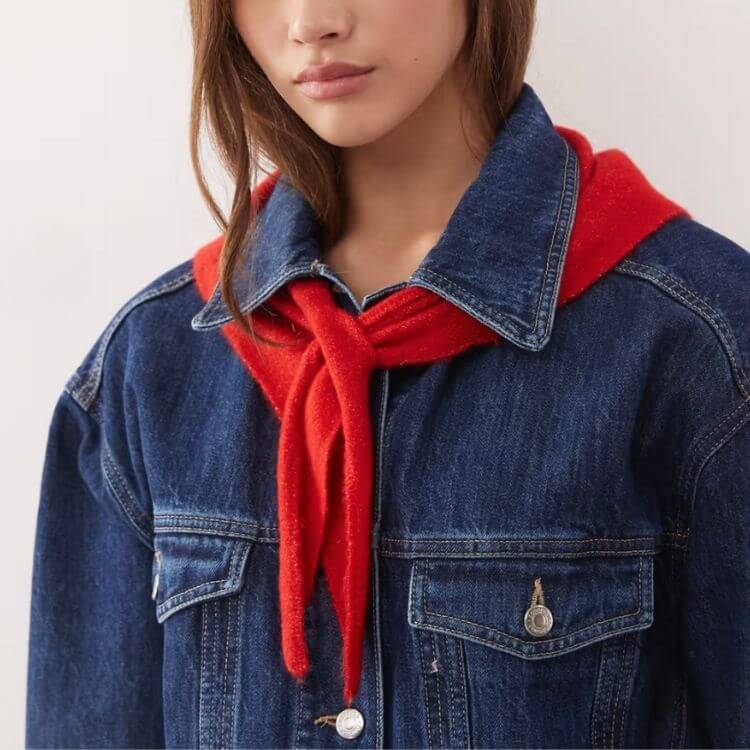 A vintage-style red triangle-shaped scarf with fringe details.