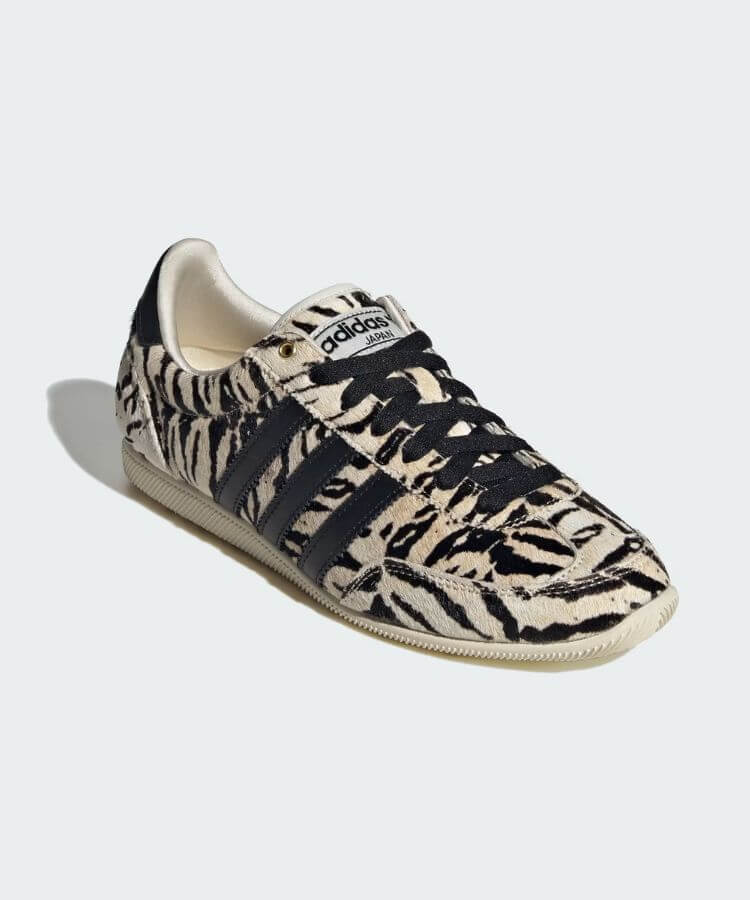 Adidas black and white sneakers with zebra-style patterns.
