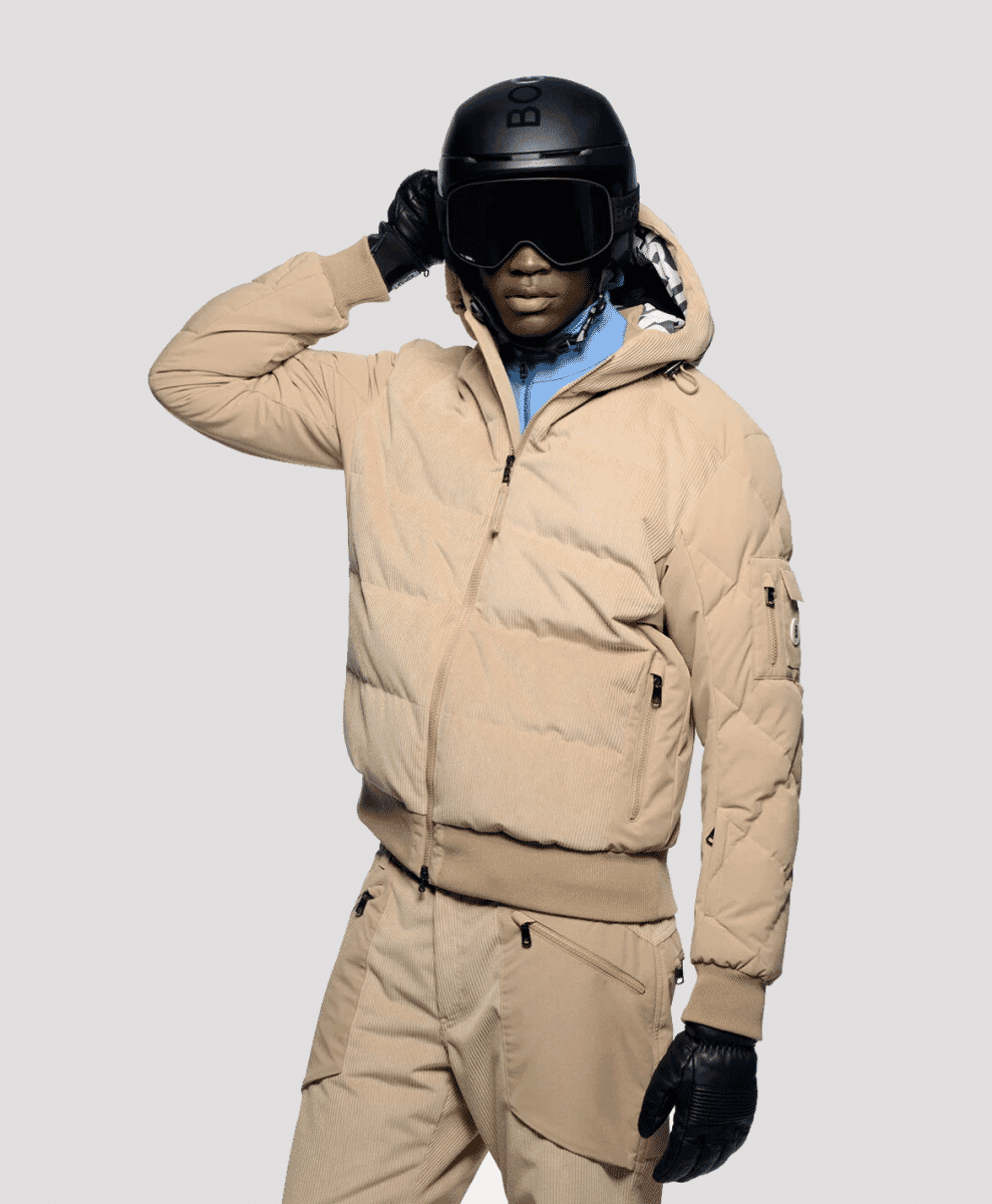 A model in a monochromatic beige corduroy ski jacket and matching pants.