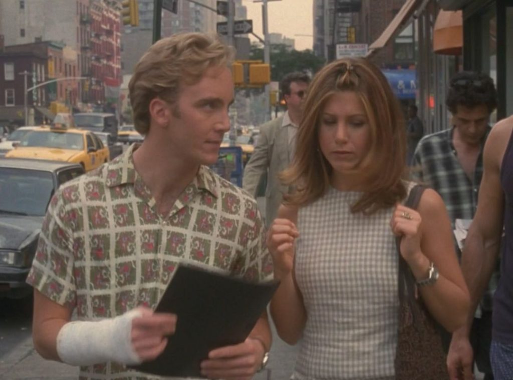 Jennifer Aniston wearing a gingham patterned top.