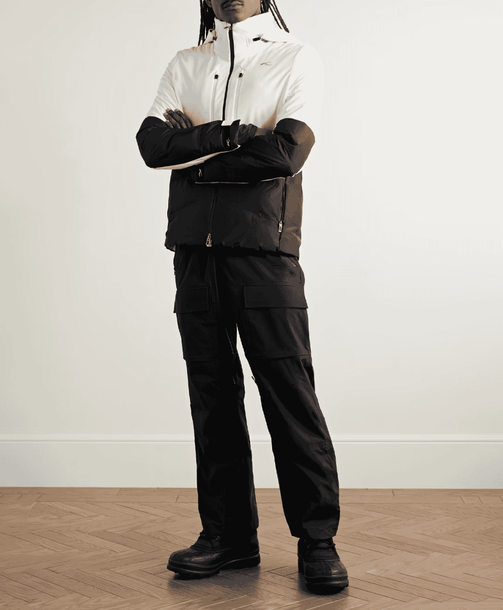 A model in a tailored white and black color-blocked ski jacket.