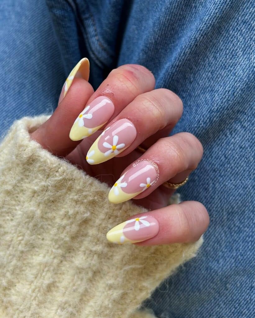 Long almond nails with butter yellow French tip design.