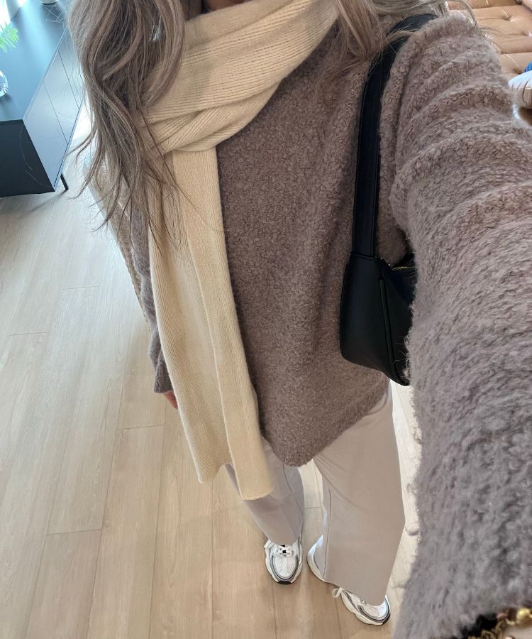 A woman wearing a coordinated wide-leg sweatpant set that looks structured and professional.