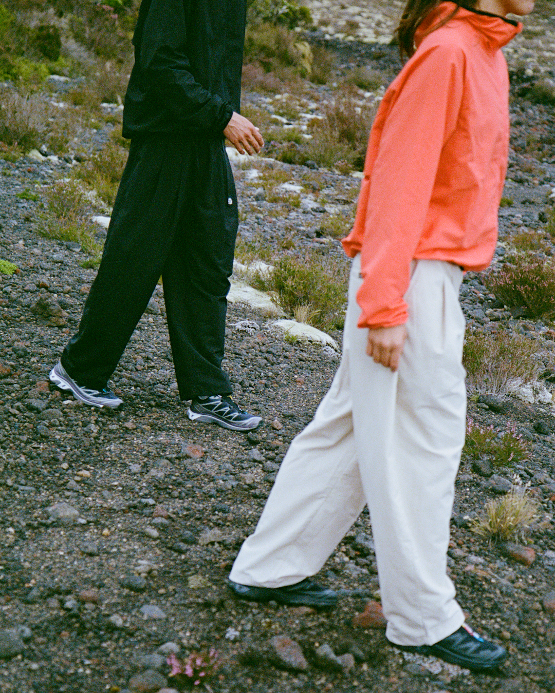 A person walking in the wind, showing the back venting and relaxed fit of the hemp windbreaker.