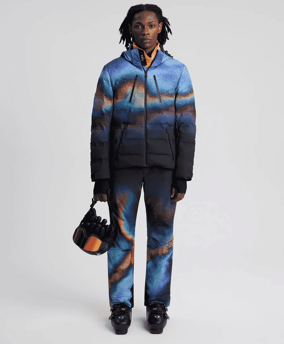 A model in a blue and orange gradient ski suit.