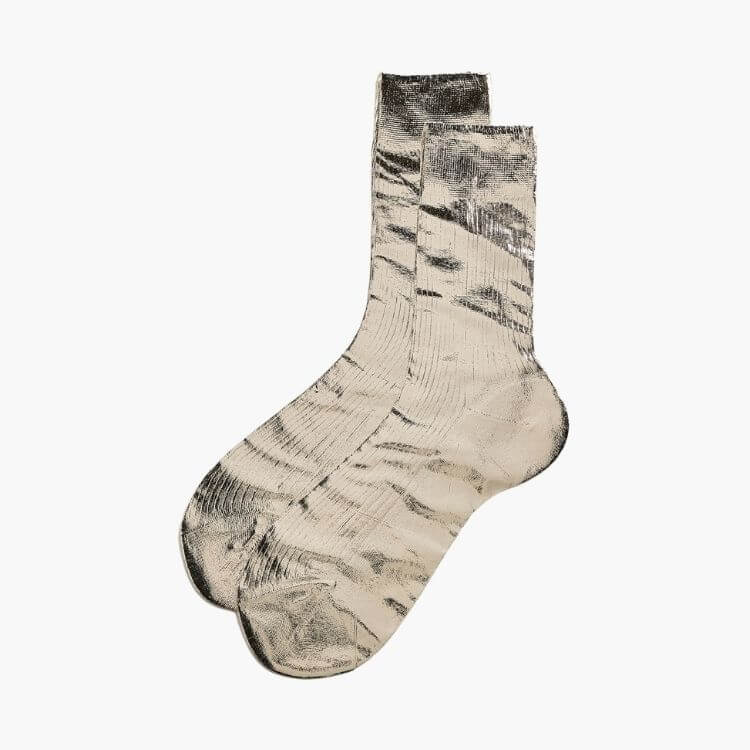Pair of delicate ribbed silk socks in a soft neutral tone.