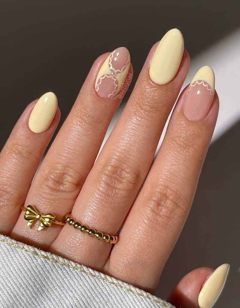 Medium almond nails with a custard-yellow finish.