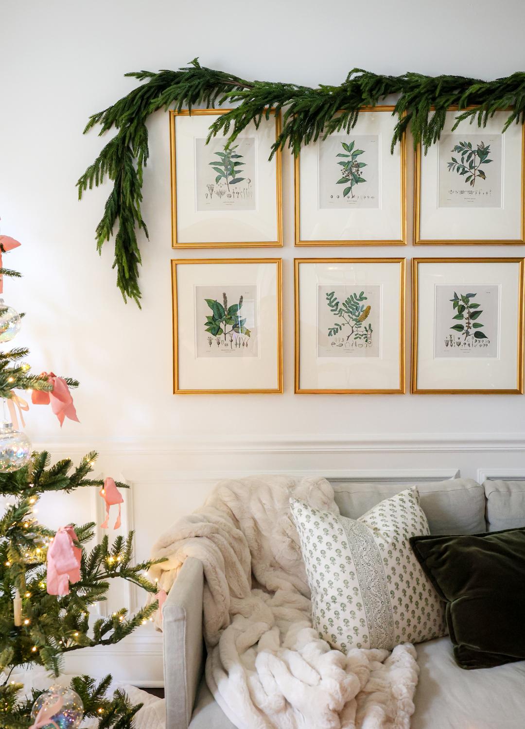 A cozy living room nook featuring a lit Christmas tree and plush textures.