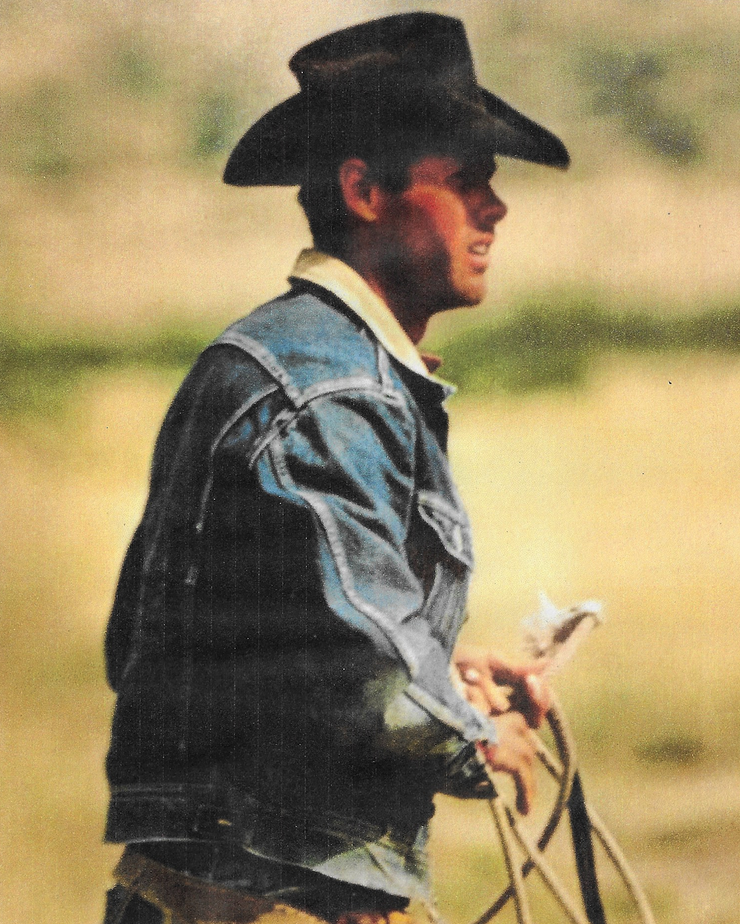 Layered look featuring a vintage flannel shirt under a denim jacket.
