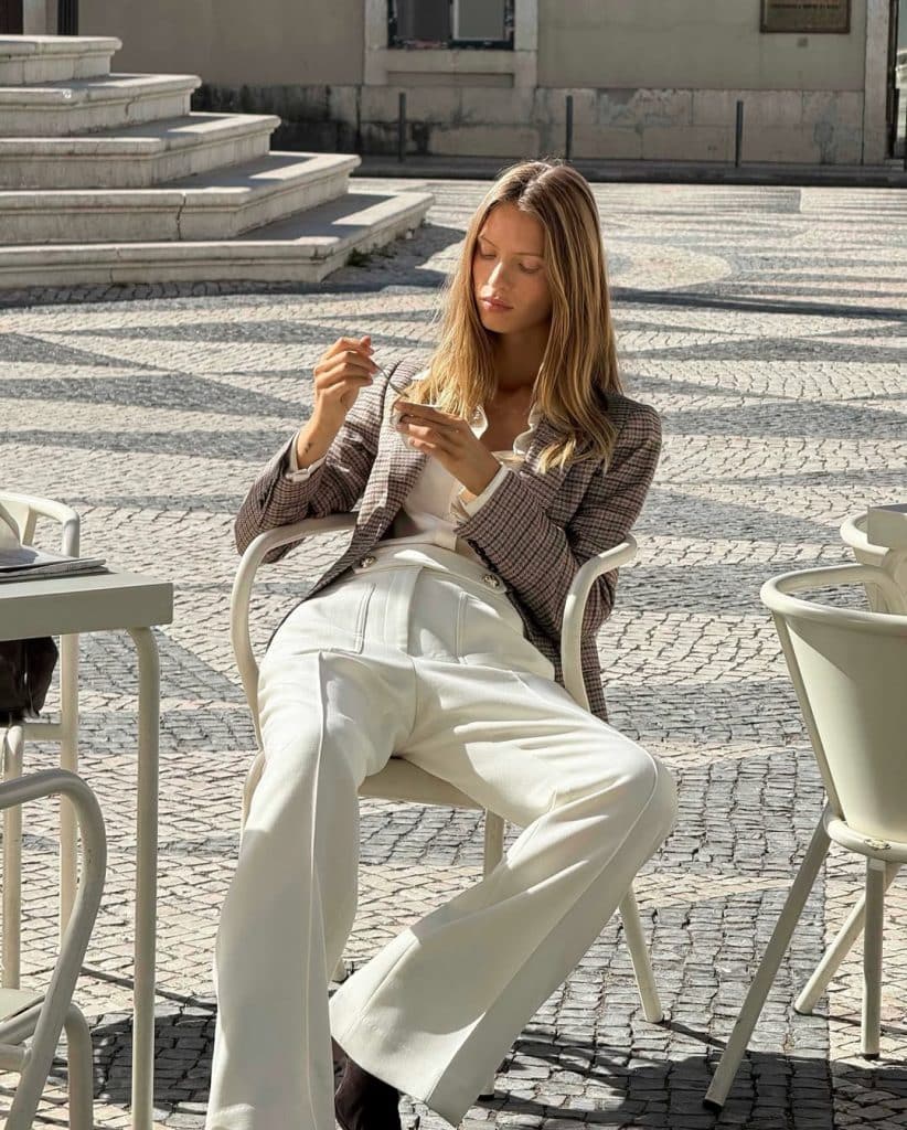 Tailored wool coat and textured knit polo representing British high-street craftsmanship.