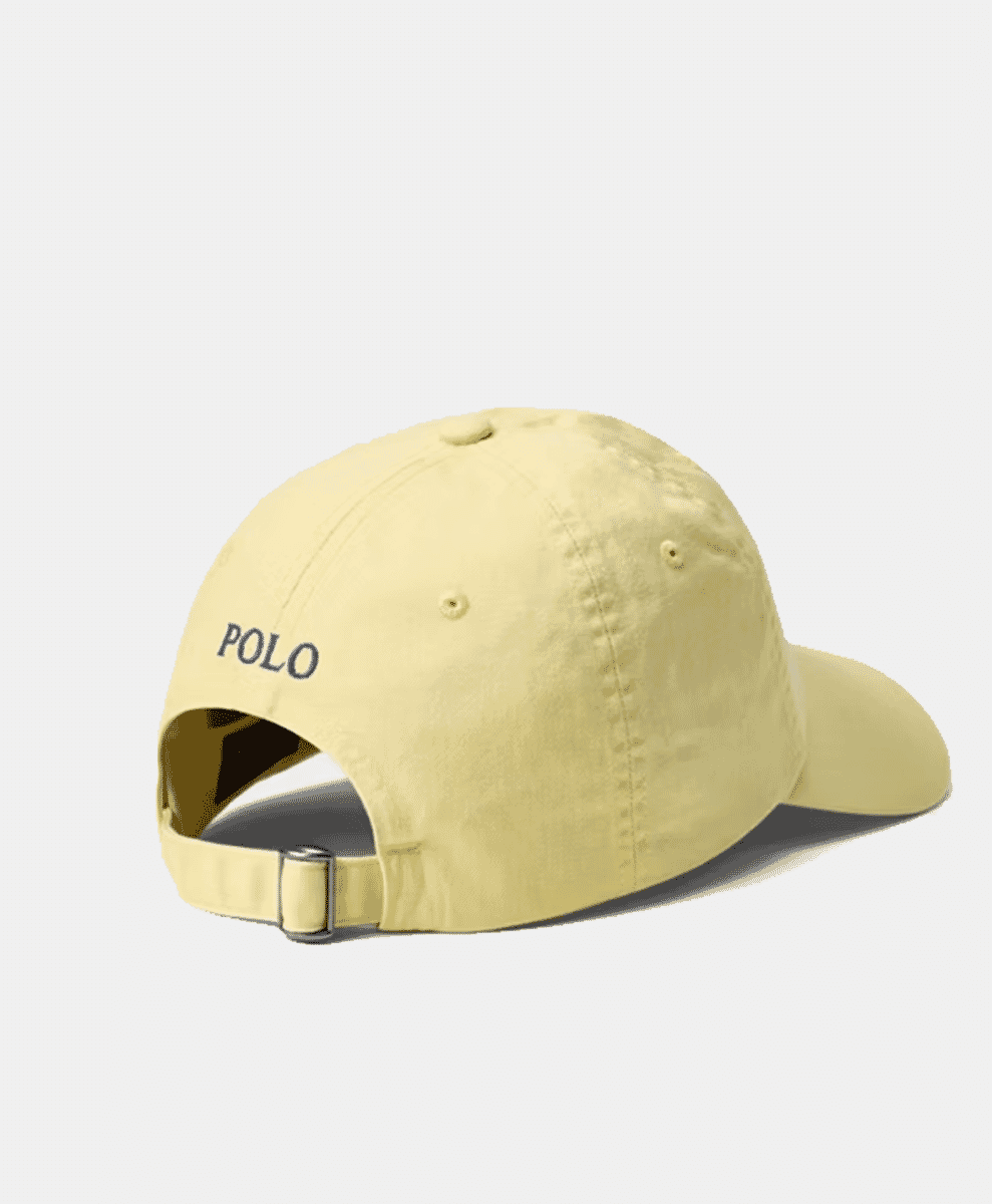 Back view of a pale yellow Polo cap featuring 'POLO' embroidery and an adjustable slider.