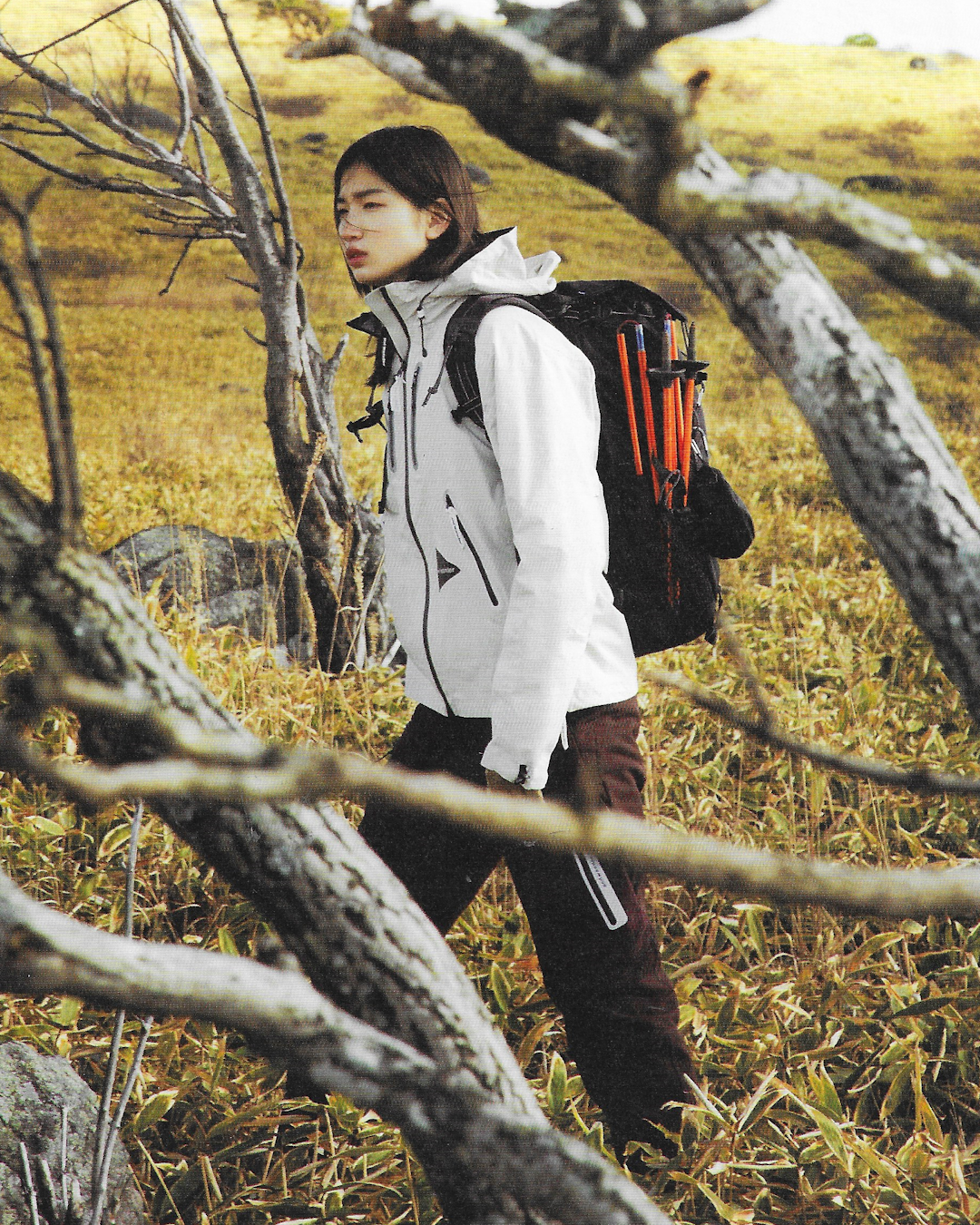 Full-body outfit showing layered gorpcore clothing including a vest, technical pants, and a crossbody bag.