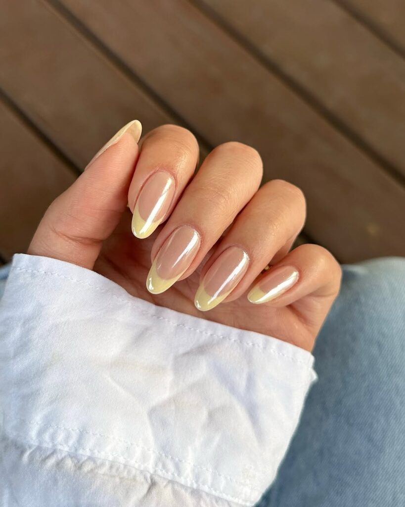 High-gloss creamy butter yellow manicure on almond-shaped nails.