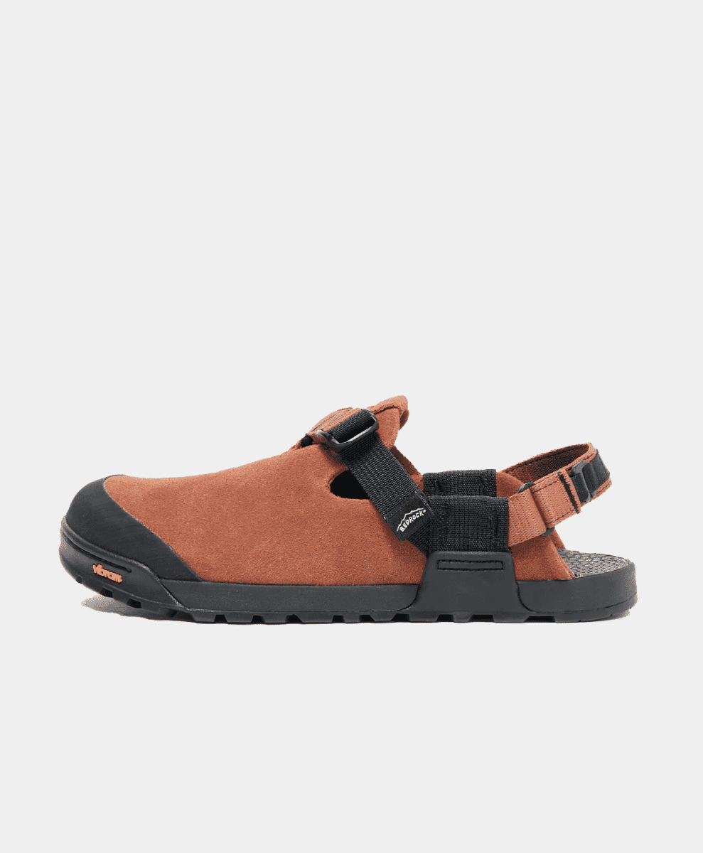 Side view of a brown suede Bedrock sandal against a white background.
