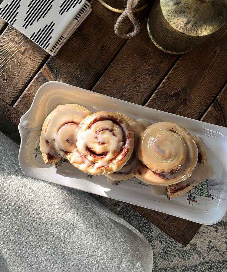 Friends gathered in a festive, decorated living room sharing a joyful moment.