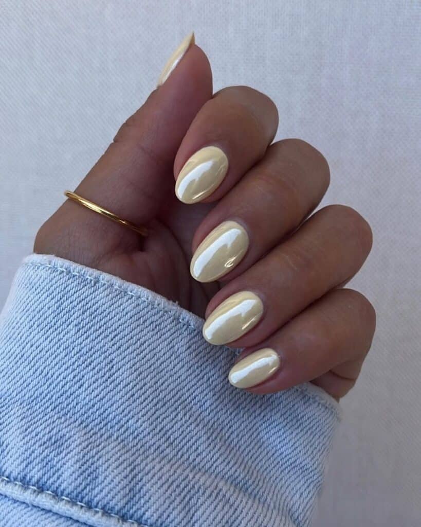 Short square nails with a smooth butter yellow gel finish.