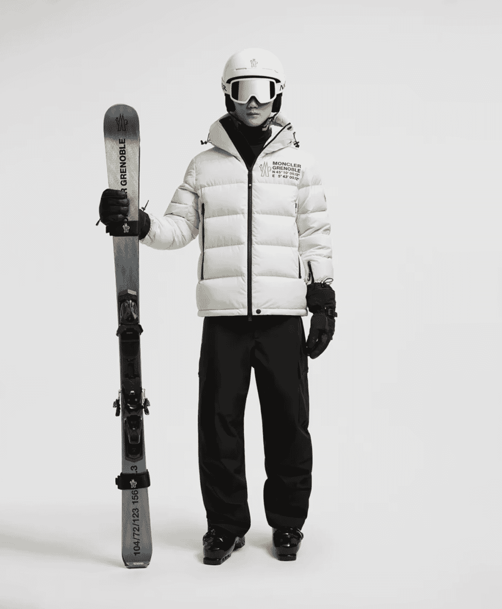 White quilted Moncler Grenoble puffer jacket and ski gear.