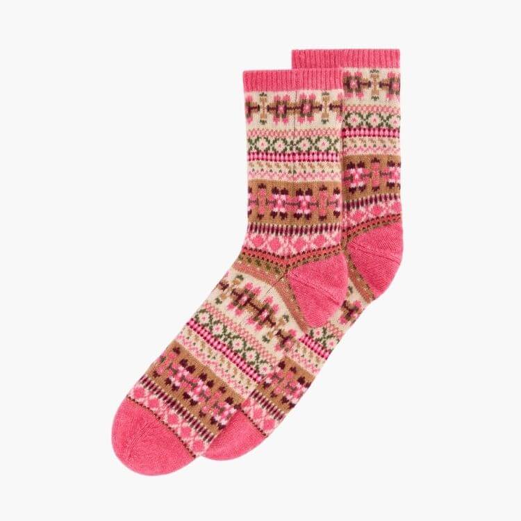 Colorful socks featuring a traditional Fair Isle pattern with pink accents.