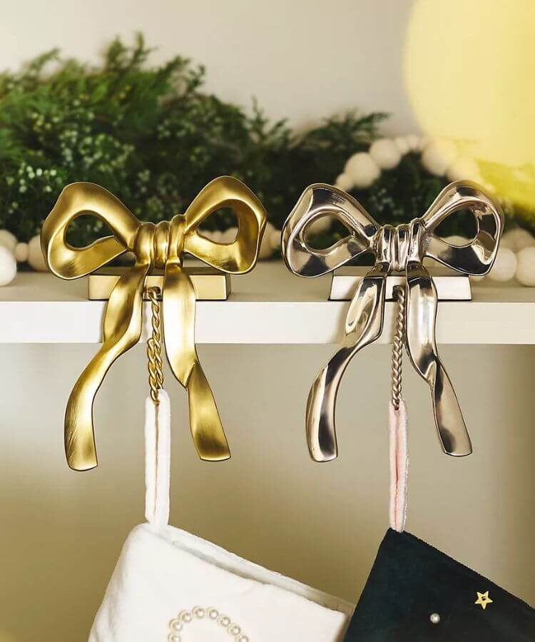 Gold bow-shaped metal stocking holder.