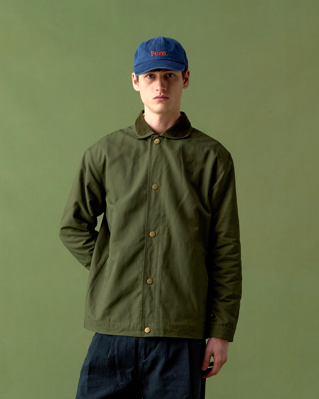 Mid-shot of a knitted rugby shirt layered under a vest, emphasizing the collar and knit texture.