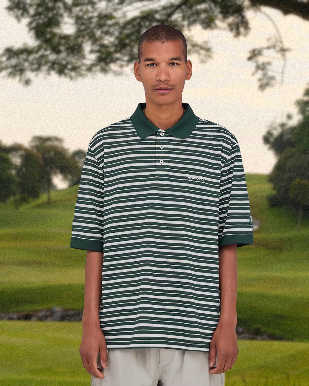 Malbon Divot Camo Rain Jacket worn in an outdoor environment.